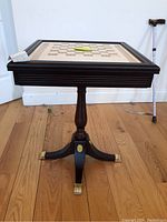 Front angle view of entire chessboard table showing top surface and pedestal base