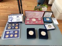 Overview of all items on table: proof sets, presentation case, Eagle boxes