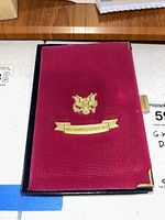 Closed red velvet case with gold embossed U.S. eagle and “10th Anniversary Set” banner