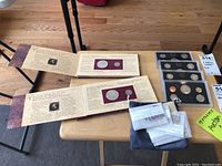 Two Thomas Jefferson coinage and currency sets with displayed coin inserts and informational text inside.