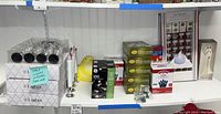 Shelf view showing various electrical items including three boxes of table lights, LED bulbs and other lighting accessories.