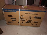 Photo of the boxed unopened Exerpeutic Recumbent Bike showing the front with bike features and branding.