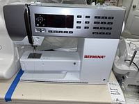 Front view of sewing machine showing LCD screen, keypad and Bernina logo