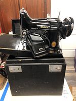 Front-right view of Singer machine seated in open black hard case