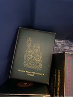 Box with illustration and name 'Victoria Anne with Stuart & Abigail' for a Boyds Bears figurine.