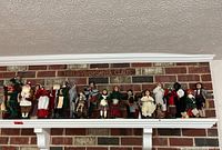 Shelf view showing full row of 24 figures against brick wall