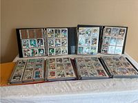 7 binders arranged on table displaying numerous 1993 Topps baseball cards in plastic sleeves.