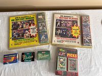 Full view of all unopened card packs showing front covers, brands, and bonus cards in holders.