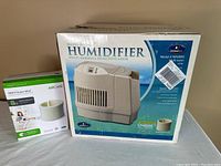 Photo showing Essickair humidifier box and Aircare MA2 Super Wick replacement box side by side.