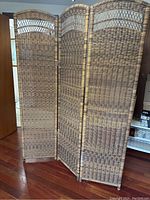 Full view of the three-panel folding screen showing woven pattern and overall structure.