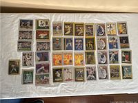 Full view of 40 baseball cards laid out on a flat surface, showing various designs and players.