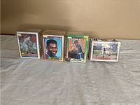 Four plastic boxes containing stacks of Topps baseball cards with front cards visible: Scott Radinsky, Jeff Jackson, Paul Coleman, and Travis Fryman.
