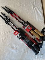 Two sets of trekking poles showing cork and foam grips, tags attached.