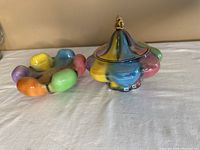 Wide view of vintage Italian rainbow majolica covered dish and six-sectioned bowl on cloth background