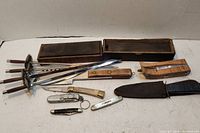 Overview photo of blades, skewers, knives, and sharpening stones with cases