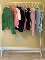 Rack of 10 Zara women's tops in various colors and styles, size 1X, new condition.