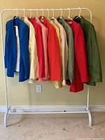 Full rack view showing all ten blazers hung in a row
