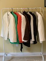 Rack display of ten blazers in various colors hung on a white metal garment rack.