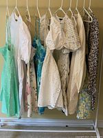 Full rack view showing ten dresses in various colors and prints