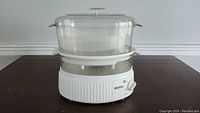Full view of Kenmore vegetable steamer showing transparent basket and white electric base
