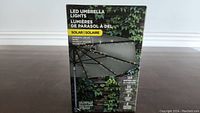 Product box for LED umbrella lights showing product type and solar power feature.