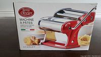 Boxed Remy Olivier pasta machine with chrome steel rollers and red base, showing front and brand label