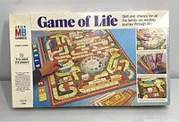 Box of the Game of Life from 1977 by Milton Bradley showing the front label and images of the board and cards