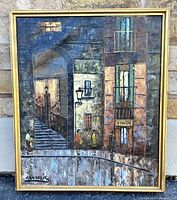 Frontal view of the signed oil painting showing detailed street scene and artist signature.