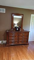 Full view of walnut dresser with mirror on top showing overall condition and style in room setting