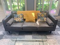 Front view of entire sofa with cushions and throw