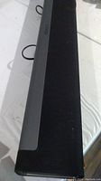 Front angled view of black Sonos Playbar on white surface