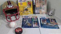 Wide shot showing all items in the lot: helmet, baseball, puck, mini trophy, and 4 packaged baseball action figures