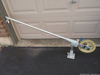 Side view of the downrigger showing the long arm, mounting base, and reel assembly.