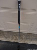 Full view of golf putter showing Golf Pride grip and putter shaft.