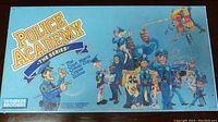 Photo of front face of sealed Police Academy The Series board game box showing cartoon characters and title.