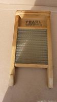 Full view of the vintage washboard showing wooden frame and glass scrubbing surface.