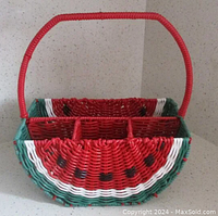 Front view of the watermelon themed basket showing the handle and four compartments inside.