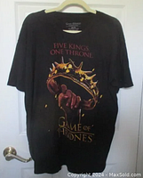 Full front view of the black Game of Thrones T-shirt with graphic showing a hand holding a crown and the text 'FIVE KINGS ONE THRONE'.