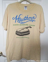 Photo showing the full T-shirt front side with Hawthorn logo and banjo graphic and text.
