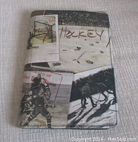 Leather case with hockey-themed images and text 'HOCKEY' printed, showing front view of case