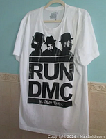 Full view of the white T-shirt showing the Run DMC black graphic print on front.