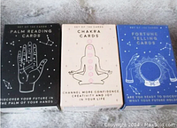 Photo showing front of each sealed mini card deck box: Palm Reading Cards, Chakra Cards, Fortune Telling Cards.