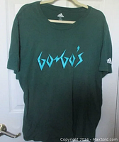 Front view of dark green t-shirt with light blue Go-Go's logo and Adidas tag on neckline