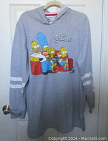 Full view of grey hooded sweatshirt featuring The Simpsons graphic and white stripes on sleeves