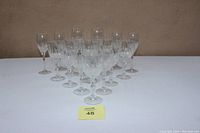 Front view of the entire 17-piece crystal stemware set arranged in rows showing the difference in glass shapes and sizes.