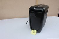 Front view of the Fellowes 60Cs paper shredder showing compact black plastic body with paper slot on top.