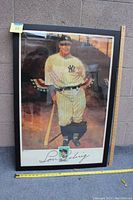 Framed print of Lou Gehrig in New York Yankees uniform with commemorative stamp, measured with a tape showing approx. 38" L x 27" W.