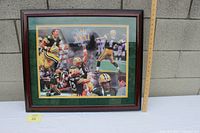 Framed signed Green Bay Packers Super Bowl XXXI photo with ruler to show size, placed against wall.