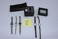 Photo overview of six ladies watches: three with chain bands on the left, three with leather bands on the right, plus boxes for Fossil and Coldwater Creek.