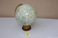 Large 12-inch GlobeMaster globe on white cloth with a measurement ruler to show height.